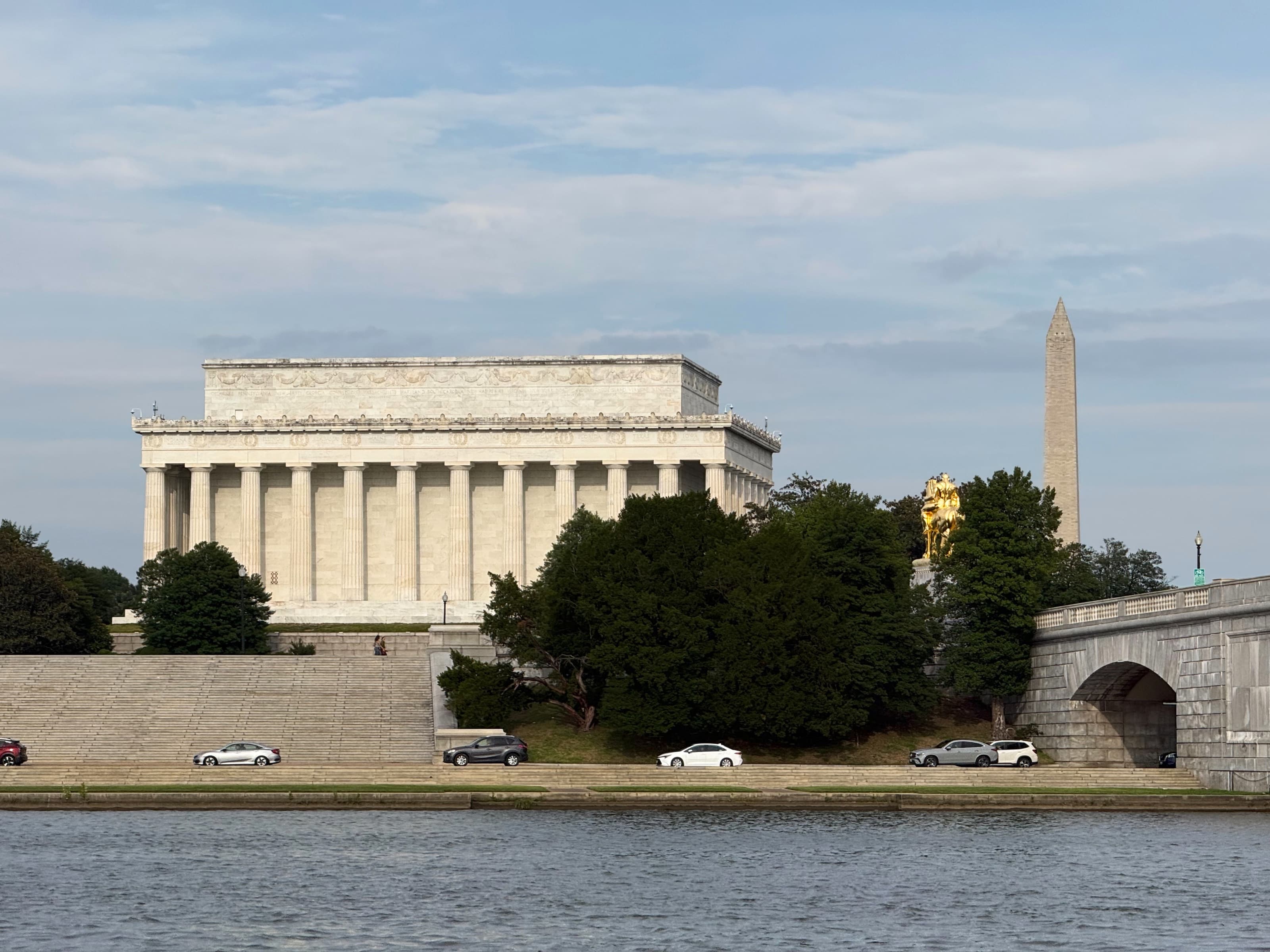 The Lincoln Memorial and Washington Monument, with the gilded Valor statue, from the Potomac River.