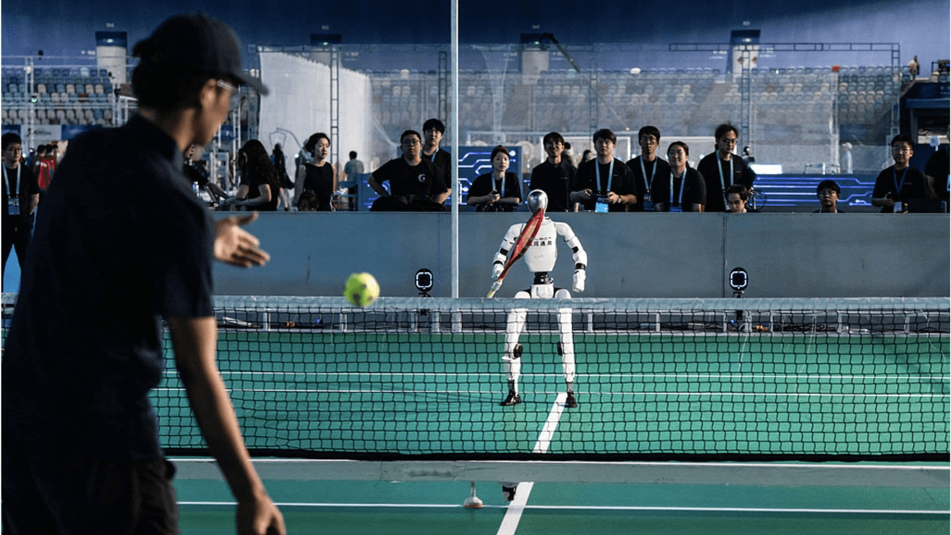 A Galbot humanoid returning a shot during an autonomous tennis demonstration